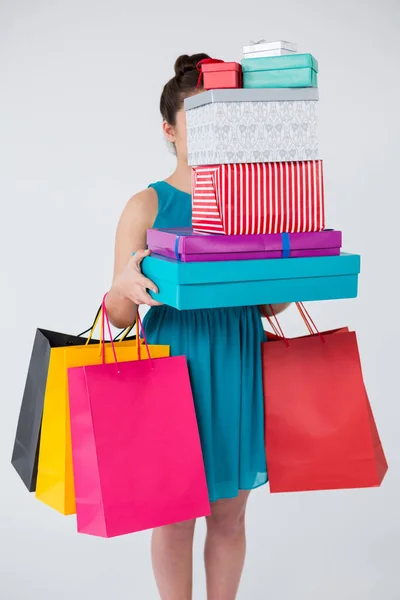 Woman carrying boxes and shopping bags — Stock Photo, Image