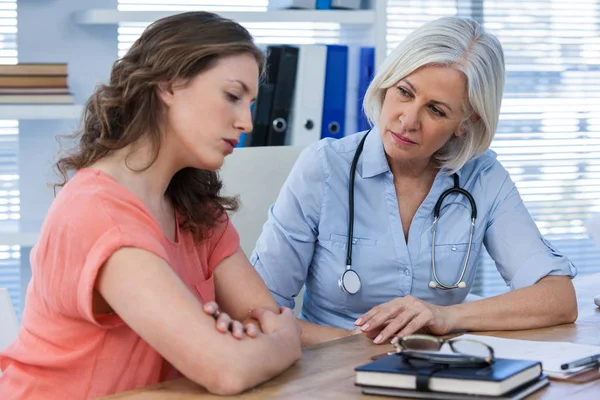 Doctor consoling patient Stock Image