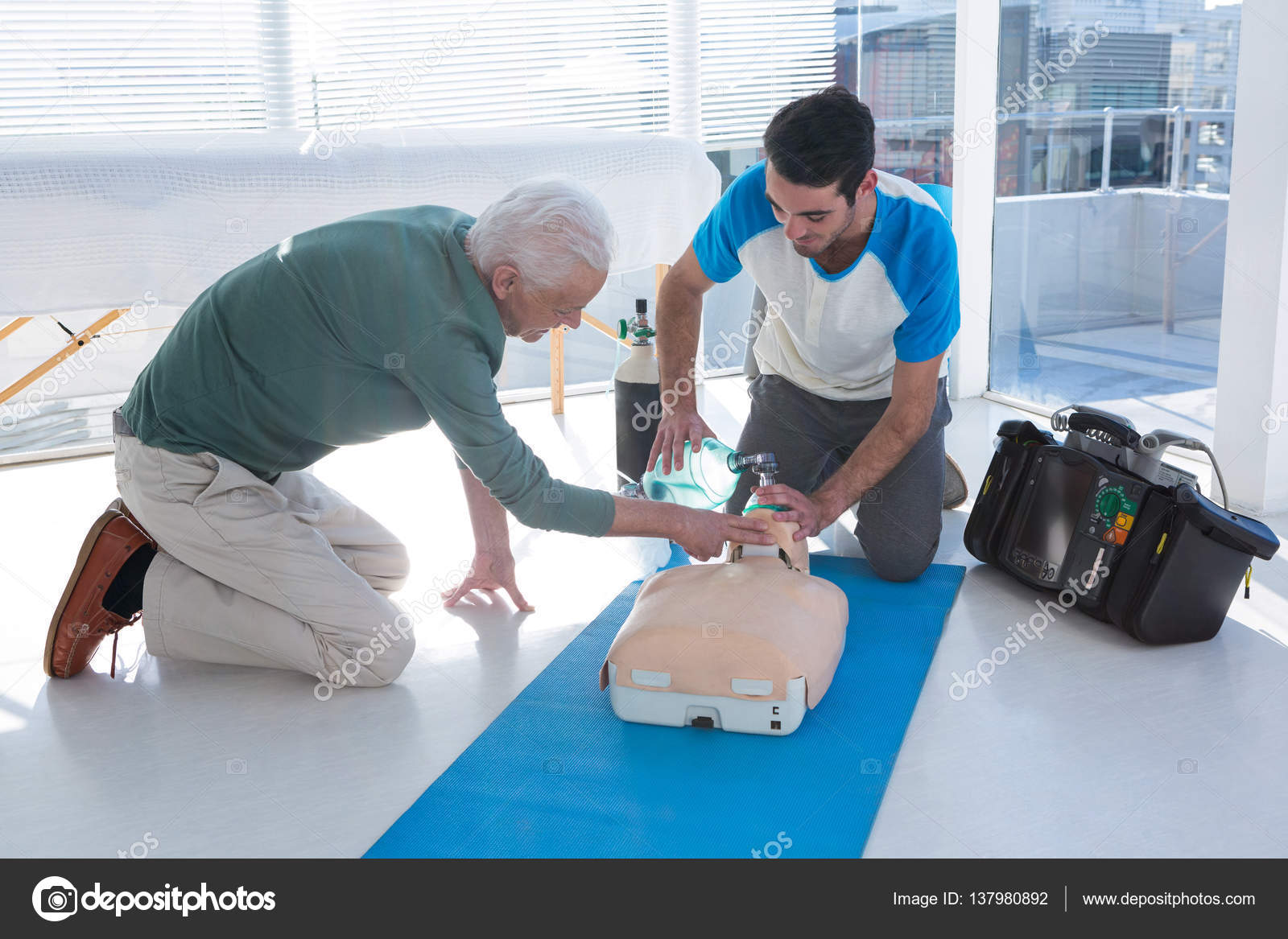Paramedics practicing cardiopulmonary resuscitation on mannequin Stock