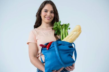 Beautiful woman carrying grocery bag clipart