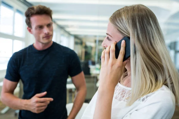 Female graphic designer talking on phone — Stock Photo, Image