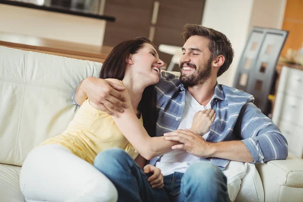 Happy couple relaxing on sofa — Stok Foto