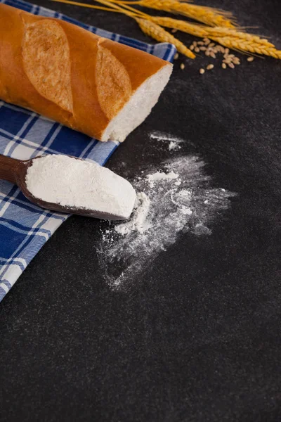 Bread loaf with wheat grains and flour — Stock Photo, Image