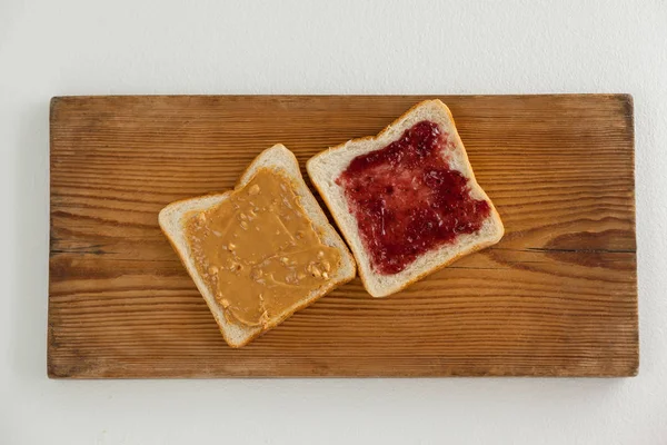 Bread slices with jam and peanut butter — Stock Photo, Image