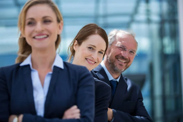 Business people standing with hands crossed — Stock Photo, Image