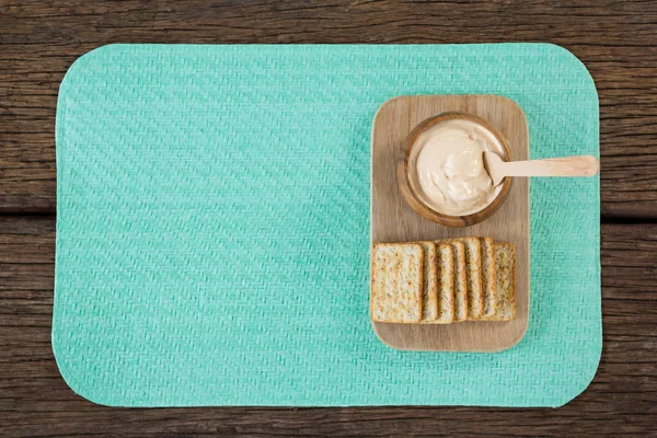Cheese sauce with bread on serving board — Stock Photo, Image