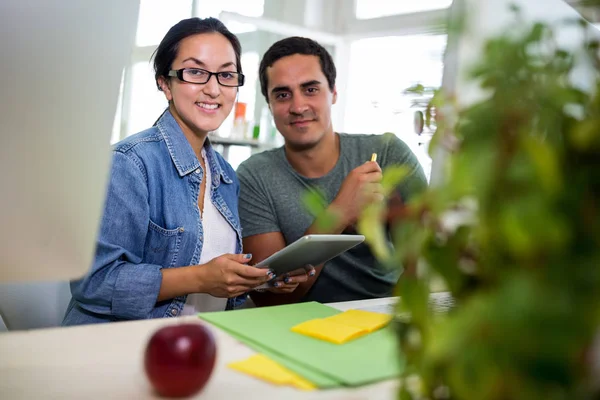 Grafisch ontwerpers met behulp van Tablet PC aan balie — Stockfoto