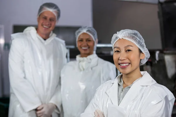 Team of butcher standing in meat factory — Stock Photo, Image