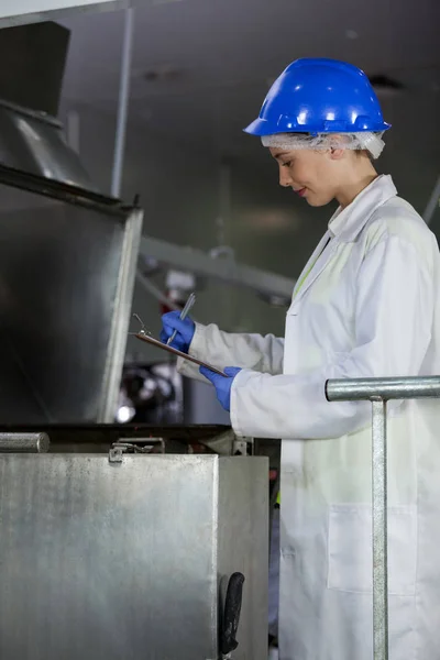 Technician examining meat processing machine — Stock Photo, Image