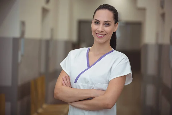 Female nurse standing in corridor — Stock Photo, Image