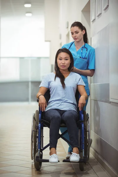 Nurse assisting patient on wheelchair — Stock Photo, Image
