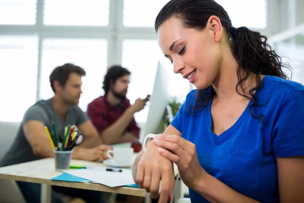 Smiling business executive checking time — Stock Photo, Image