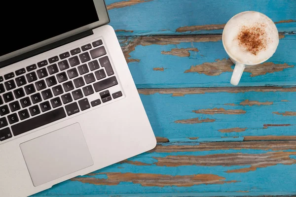Kávé bögre és a laptop a fából készült deszka — Stock Fotó