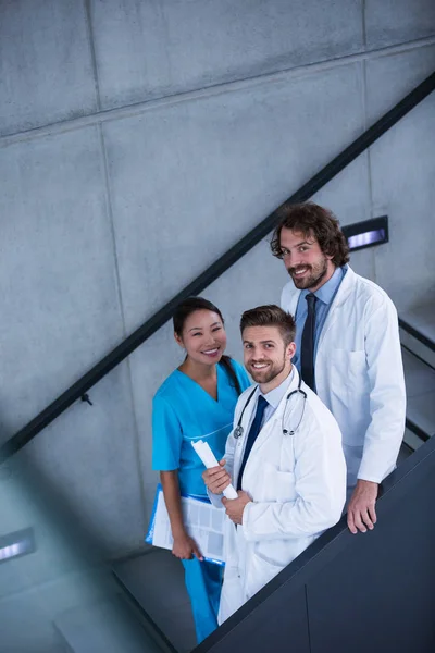 Doctors and nurse holding medical reports — Stock Photo, Image
