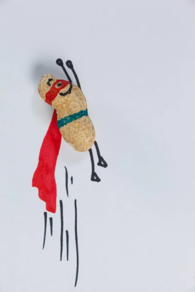 Peanut figurine pretending to be superhero — Stock Photo, Image