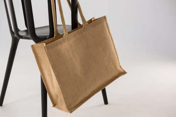 Jute bag hanging on a black chair — Stock Photo, Image