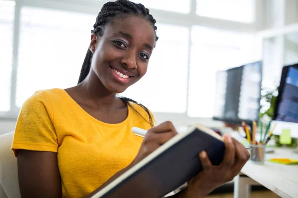 Woman writing in diary — Stock Photo, Image