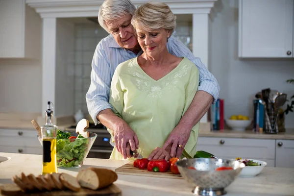 Casal sênior corte de legumes — Fotografia de Stock