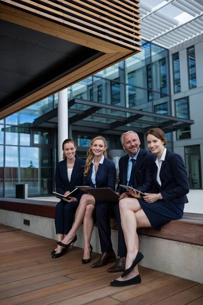 Businesspeople sitting with laptop — Stock Photo, Image