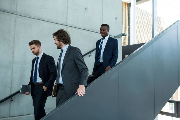 Groep zakenlieden klimmen trappen af — Stockfoto