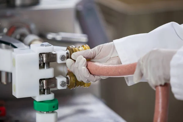 Butchers processing sausages — Stock Photo, Image