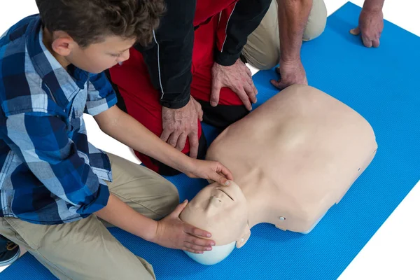 Paramedic training cardiopulmonary resuscitation to boy — Stock Photo, Image