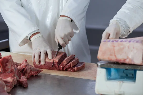 Мясники режут мясо — стоковое фото