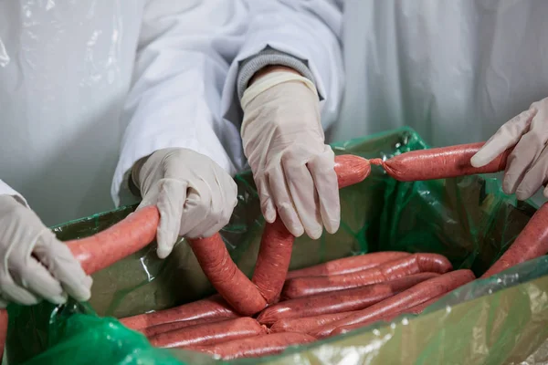 Açougueiros processando salsichas — Fotografia de Stock