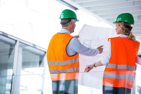 Architects discussing with blueprint — Stock Photo, Image