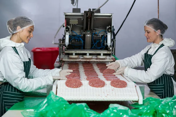 Butchers processing hamburger patty — Stock Photo, Image