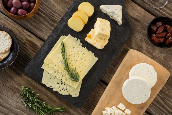 Cheese, olives, biscuits and rosemary herbs — Stock Photo, Image