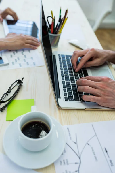 Business executive using laptop at desk — Stock Photo, Image