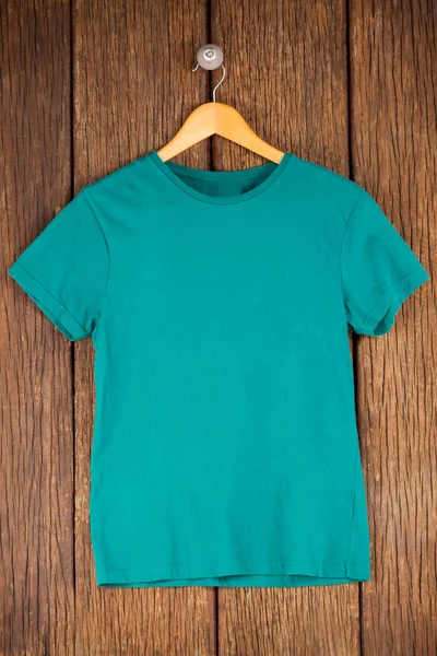 Turquoise t-shirt on hanger — Stock Photo, Image