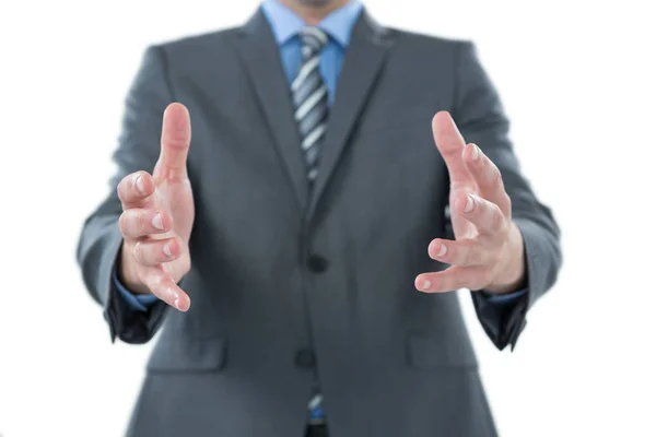 Businessman gesturing against white background — Stock Photo, Image