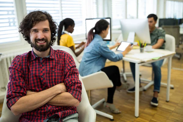 Man sitting with arms crossed on chair — Stock Photo, Image