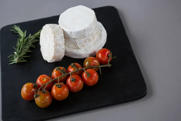 Cheese with cherry tomatoes and rosemary herb — Stock Photo, Image