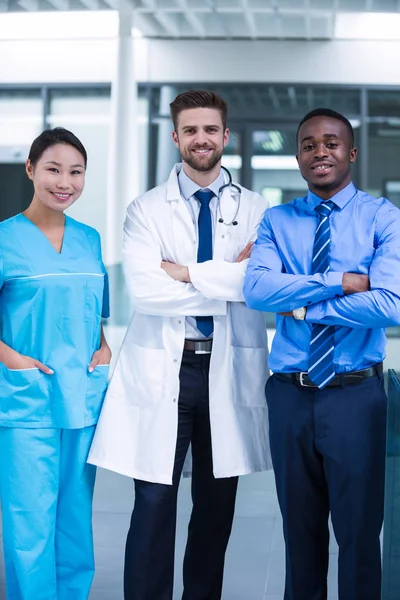 Nurse and doctor with businessman in hospital — Stock Photo, Image