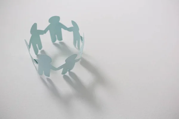 Circle of white paper cut-out figures — Stock Photo, Image