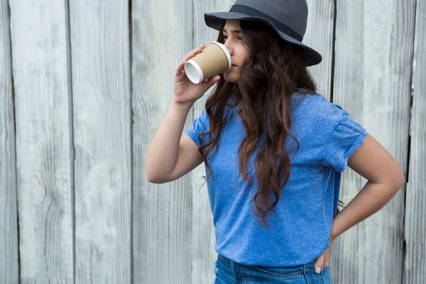 Woman in blue top drinking coffee — Stock Photo, Image