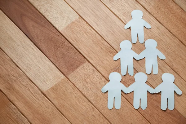 Paper cut outs forming human pyramid — Stock Photo, Image