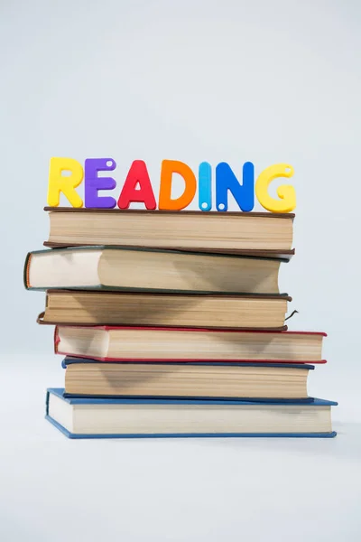 Reading letter blocks on stack of books — Stock Photo, Image