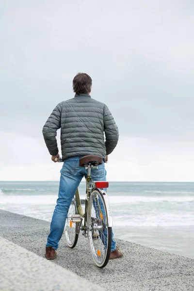 Man standing on bicycle — Stock Photo, Image