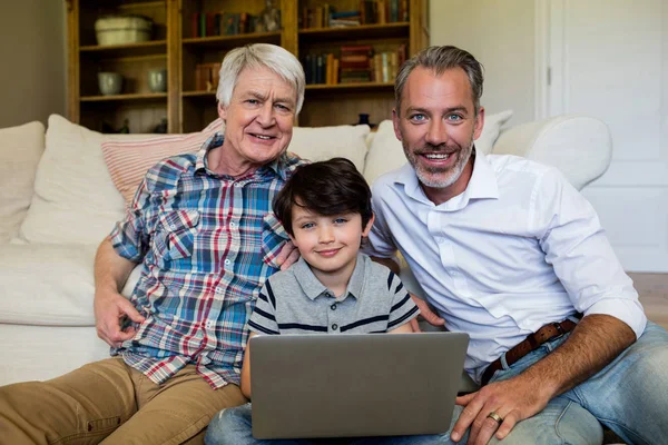 Pojke med laptop med far och farfar — Stockfoto