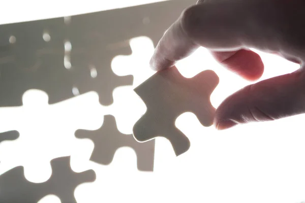 Man hands holding a puzzle piece — Stock Photo, Image