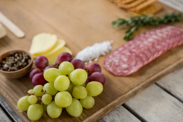 Grapes and ham with various ingredients — Stock Photo, Image