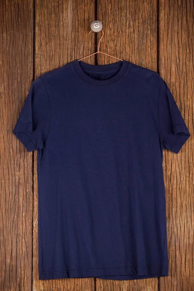 Navy blue t-shirt on hanger — Stock Photo, Image