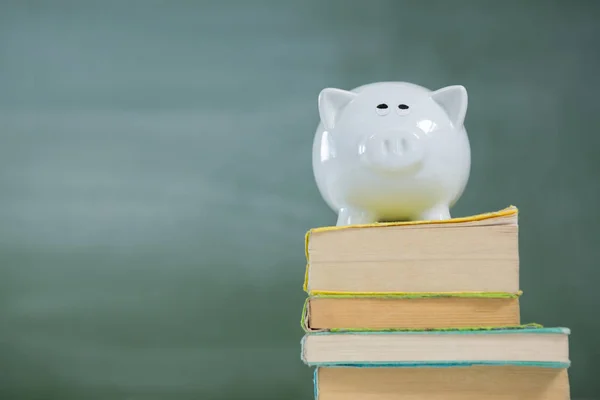 Piggy bank on stack of books — Stock Photo, Image