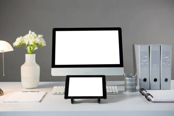Desktop pc and digital tablet with flower vase