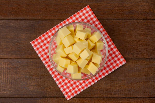 Cheese cubes in bowl on cloth napkin — Stock Photo, Image
