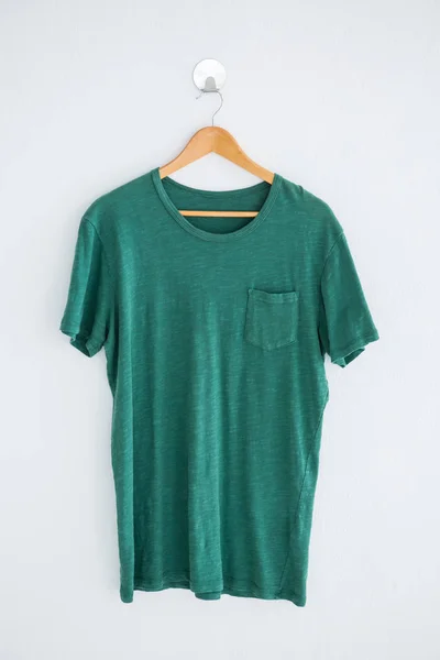 Green t-shirt on hanger — Stock Photo, Image